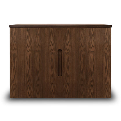 De la collection Cabinet console fini pecan | porte pleine de Humble Nature, cette armoire en bois foncé présente des motifs de grain visibles, un placage de chêne rouge et deux portes centrales avec poignées verticales, projetant une ombre subtile sur le fond blanc.