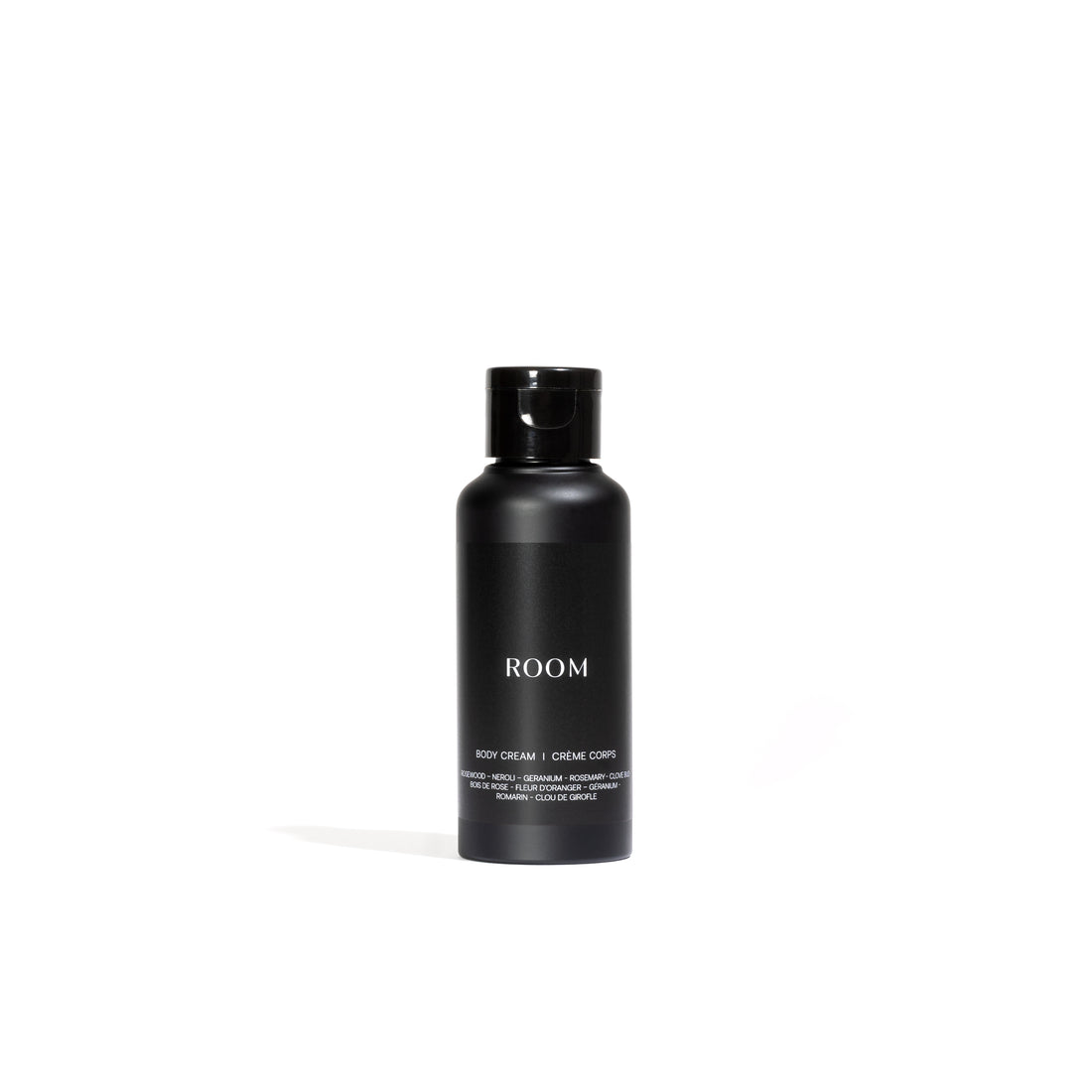 Une élégante bouteille noire de « Crème enrichie pour le corps entièrement naturelle │ ÉCHANTILLON » de Leroy Williams x Humble Nature se dresse sur un fond blanc, offrant une hydratation approfondie à laloe vera. Le texte minimaliste et élégant est parfaitement complété par le bouchon noir assorti.