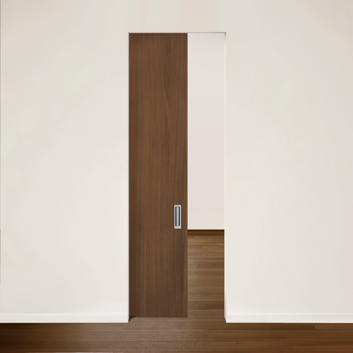 Une Porte Pure escamotable en noyer de Humble Nature est légèrement ouverte, révélant la pièce au-delà. Les planchers en bois foncé et les murs blancs correspondants reflètent le modernisme, mettant en valeur une esthétique minimaliste qui incarne le charme des portes fonctionnelles.